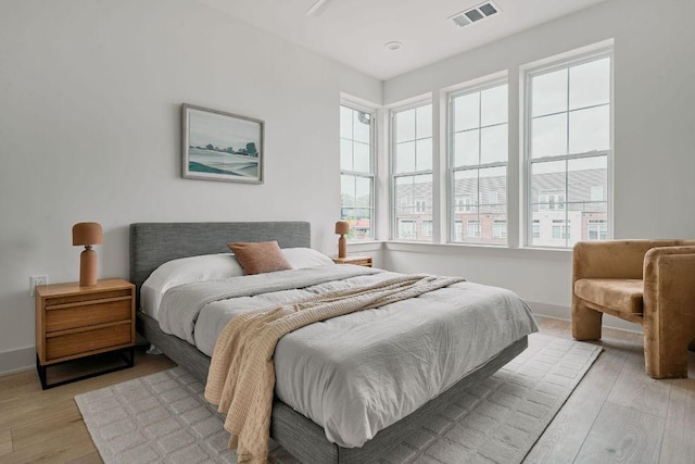 2209 Woodland Ave Unit 301, Austin, TX 78741 - bedroom featuring light wood finished floors and baseboards