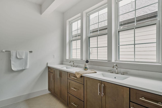 2209 Woodland Ave Unit 301, Austin, TX 78741 - full bath with tile patterned floors, healthy amount of natural light, double vanity, and baseboards