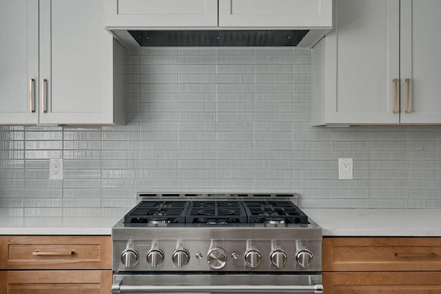 2209 Woodland Ave Unit 301, Austin, TX 78741 - kitchen featuring stainless steel gas range oven, light countertops, tasteful backsplash, and brown cabinets