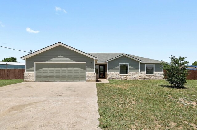 131 Roundup Dr, Liberty Hill, TX 78642 - single story home featuring stone siding, driveway, and an attached garage