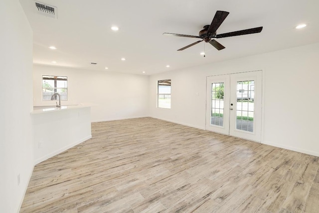 131 Roundup Dr, Liberty Hill, TX 78642 - spare room featuring light wood-style flooring, healthy amount of natural light, french doors, recessed lighting, and baseboards