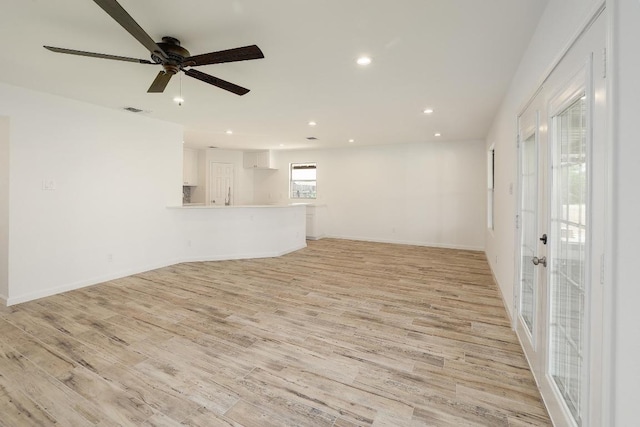 131 Roundup Dr, Liberty Hill, TX 78642 - unfurnished living room with light wood-type flooring, recessed lighting, ceiling fan, and baseboards