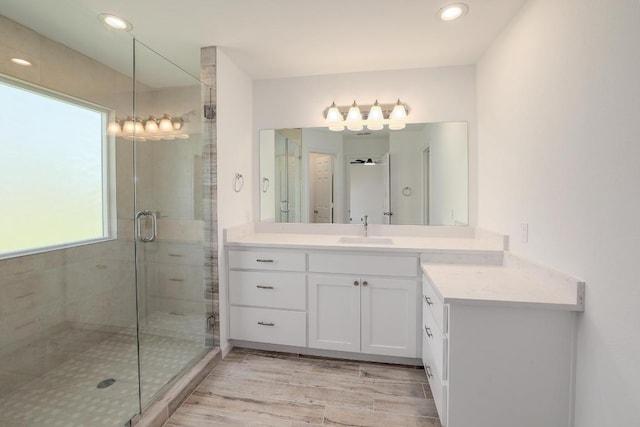 131 Roundup Dr, Liberty Hill, TX 78642 - bathroom with vanity, a shower stall, recessed lighting, and wood finished floors