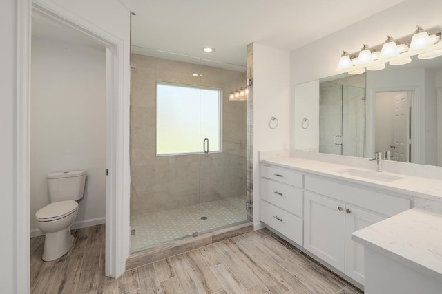 131 Roundup Dr, Liberty Hill, TX 78642 - full bath featuring a shower stall, wood finished floors, vanity, toilet, and recessed lighting