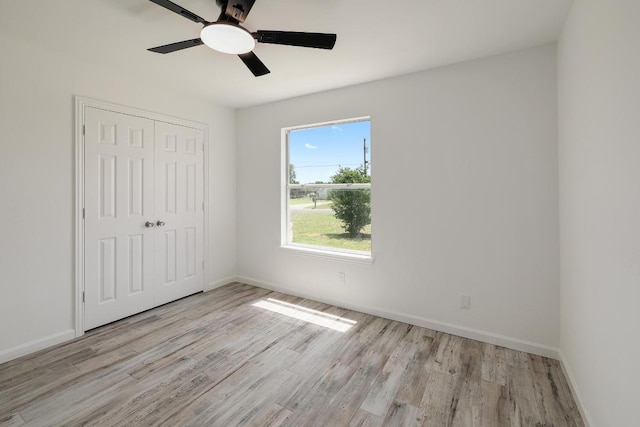 131 Roundup Dr, Liberty Hill, TX 78642 - unfurnished bedroom with light wood-style flooring, a closet, and baseboards