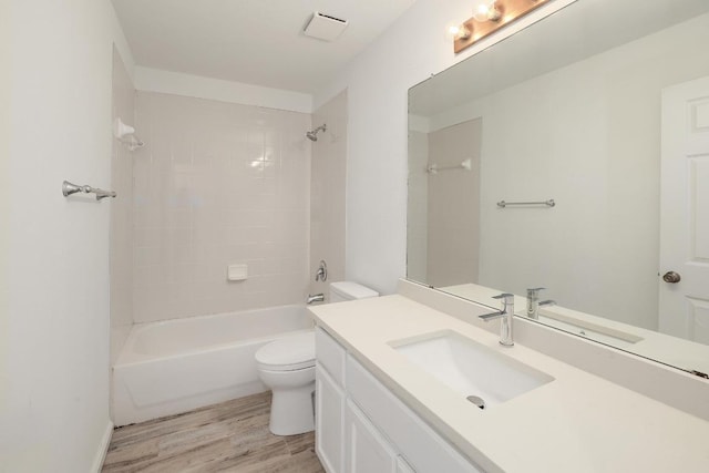 131 Roundup Dr, Liberty Hill, TX 78642 - full bathroom featuring toilet, vanity, wood finished floors, and shower / bathtub combination