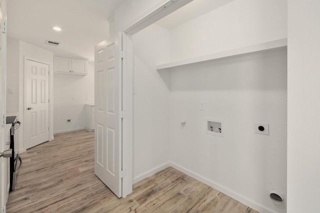 131 Roundup Dr, Liberty Hill, TX 78642 - laundry area with hookup for an electric dryer, gas dryer hookup, hookup for a washing machine, light wood-style floors, and baseboards