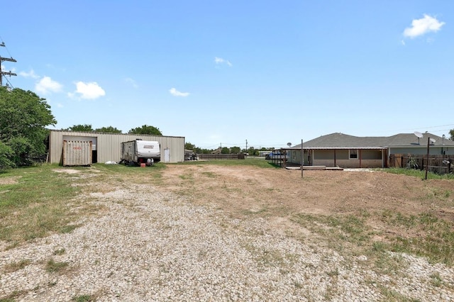 131 Roundup Dr, Liberty Hill, TX 78642 - view of yard with a garage, an outdoor structure, a pole building, and driveway