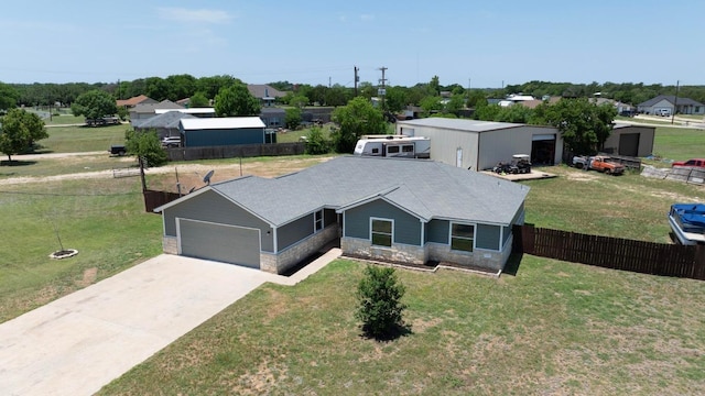131 Roundup Dr, Liberty Hill, TX 78642 - ranch-style house with stone siding, concrete driveway, and a garage