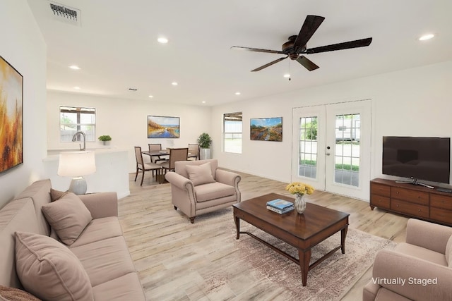 131 Roundup Dr, Liberty Hill, TX 78642 - living room featuring light wood finished floors, recessed lighting, a ceiling fan, and french doors