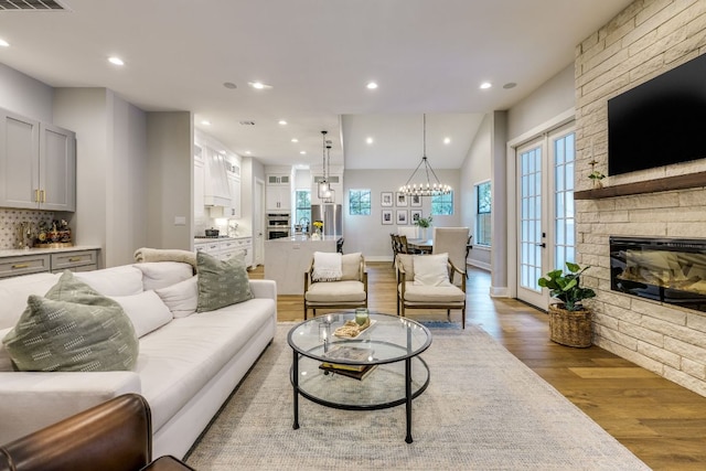5904 Hudson Bend Rd, Austin, TX 78734 - living room featuring wood finished floors, a fireplace, healthy amount of natural light, a chandelier, and recessed lighting