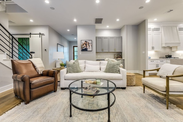 5904 Hudson Bend Rd, Austin, TX 78734 - living room with a barn door, light wood-style floors, recessed lighting, stairs, and baseboards
