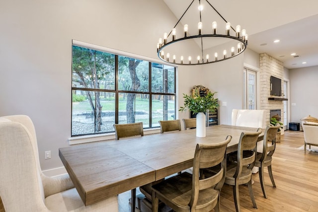 5904 Hudson Bend Rd, Austin, TX 78734 - dining area with high vaulted ceiling, light wood-type flooring, a chandelier, a fireplace, and recessed lighting