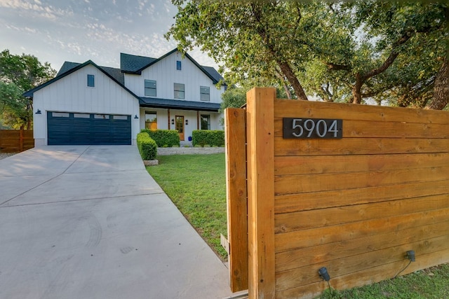 5904 Hudson Bend Rd, Austin, TX 78734 - view of front facade with board and batten siding, an attached garage, and concrete driveway