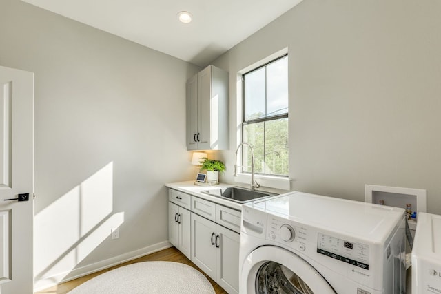 5904 Hudson Bend Rd, Austin, TX 78734 - washroom with washer / dryer, cabinet space, baseboards, and light wood-type flooring
