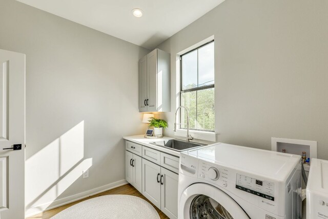 5904 Hudson Bend Rd, Austin, TX 78734 - washroom with washer / dryer, cabinet space, and light wood-type flooring