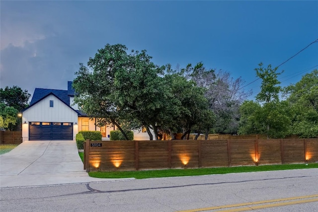 5904 Hudson Bend Rd, Austin, TX 78734 - view of front of property featuring a fenced front yard, concrete driveway, board and batten siding, and an attached garage