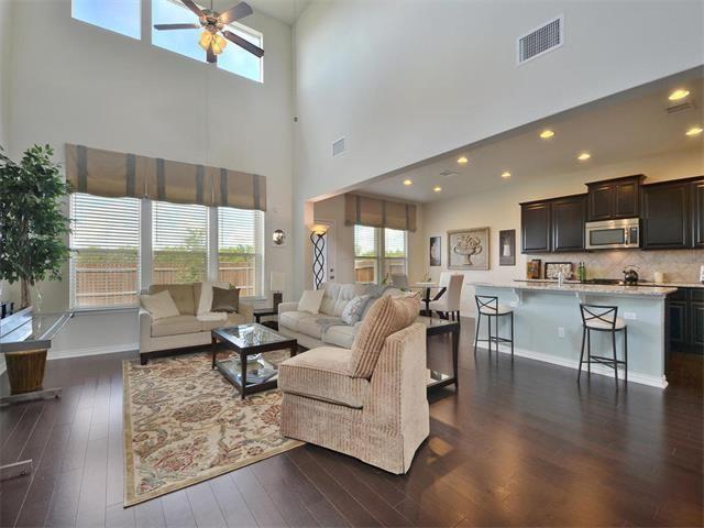 9944 Wading Pool Path, Austin, TX 78748 - living area with a ceiling fan, dark wood-style floors, a towering ceiling, recessed lighting, and baseboards