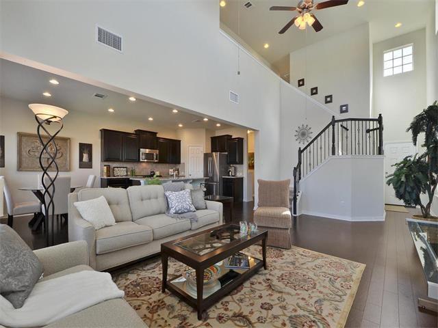 9944 Wading Pool Path, Austin, TX 78748 - living area with a towering ceiling, recessed lighting, stairway, a ceiling fan, and dark wood-style floors