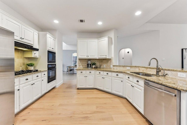 9123 La Siesta Bnd, Austin, TX 78749 - kitchen with black appliances, a sink, decorative backsplash, under cabinet range hood, and light wood-style flooring