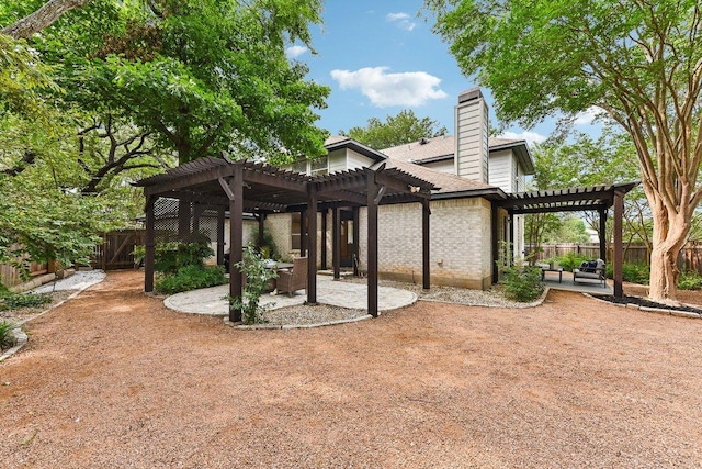 9123 La Siesta Bnd, Austin, TX 78749 - back of property with a pergola, a patio area, a fenced backyard, a chimney, and brick siding