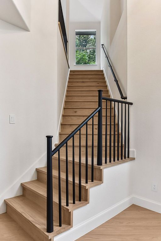 9123 La Siesta Bnd, Austin, TX 78749 - stairs featuring wood finished floors and baseboards