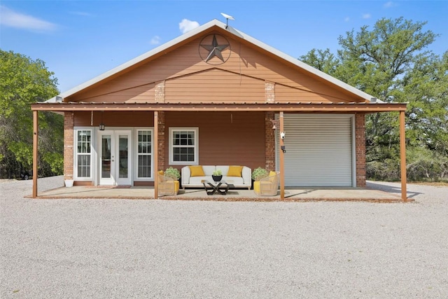 423 County Road 1010, Lampasas, TX 76550 - view of front facade with french doors, a garage, driveway, and brick siding