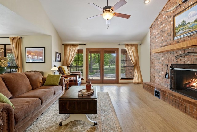 423 County Road 1010, Lampasas, TX 76550 - living room with vaulted ceiling, a brick fireplace, hardwood / wood-style floors, and ceiling fan