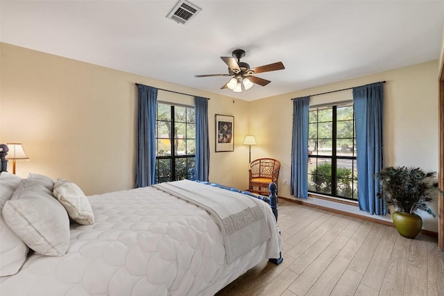 423 County Road 1010, Lampasas, TX 76550 - bedroom featuring wood finished floors, multiple windows, baseboards, and a ceiling fan