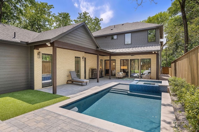 5615 Shoalwood Ave, Austin, TX 78756 - back of property featuring a patio, a fenced backyard, brick siding, a pool with connected hot tub, and a shingled roof