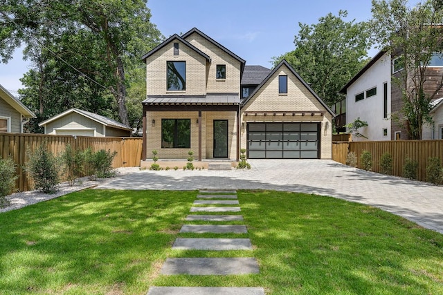 5615 Shoalwood Ave, Austin, TX 78756 - view of front of house with brick siding, decorative driveway, a garage, and a standing seam roof