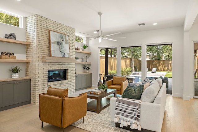 5615 Shoalwood Ave, Austin, TX 78756 - living area featuring light wood finished floors, plenty of natural light, a ceiling fan, a fireplace, and recessed lighting
