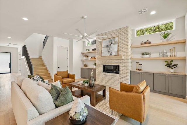 5615 Shoalwood Ave, Austin, TX 78756 - living area featuring stairway, light wood-style floors, ceiling fan, a brick fireplace, and recessed lighting