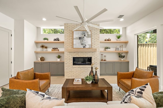 5615 Shoalwood Ave, Austin, TX 78756 - living room with ceiling fan, light wood finished floors, a fireplace, and recessed lighting