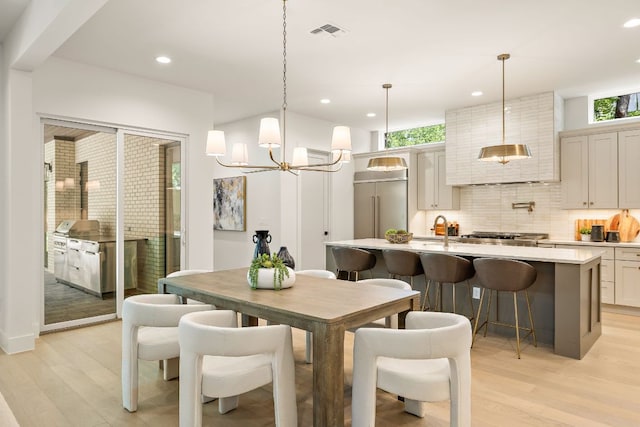 5615 Shoalwood Ave, Austin, TX 78756 - dining space with plenty of natural light, light wood-style floors, recessed lighting, and a chandelier