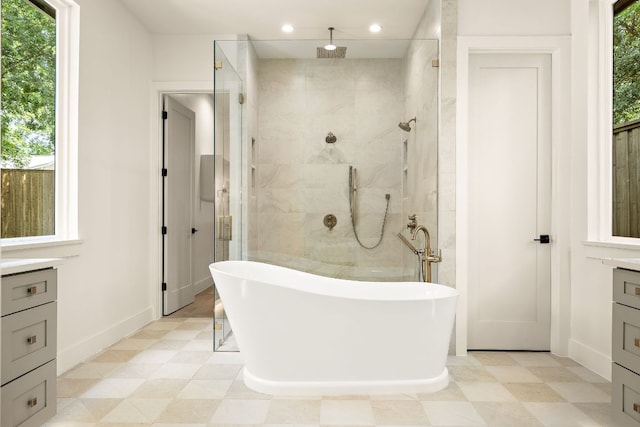 5615 Shoalwood Ave, Austin, TX 78756 - bathroom with a freestanding tub, vanity, tiled shower, recessed lighting, and baseboards