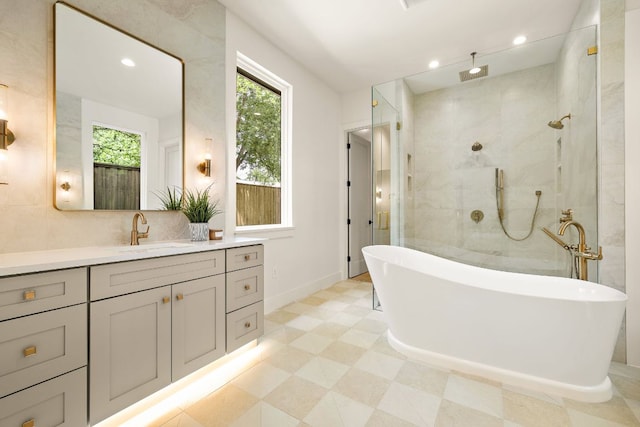 5615 Shoalwood Ave, Austin, TX 78756 - bathroom with a freestanding bath, vanity, a walk in shower, baseboards, and recessed lighting
