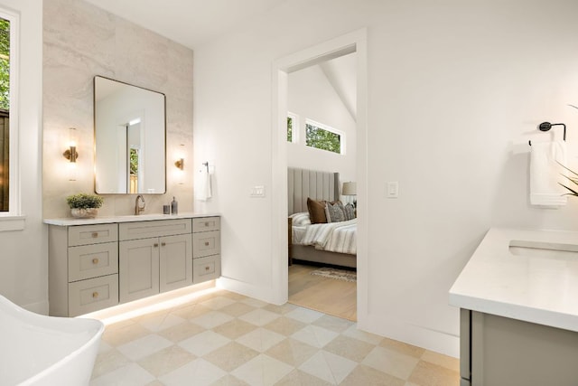 5615 Shoalwood Ave, Austin, TX 78756 - full bathroom featuring vanity, healthy amount of natural light, baseboards, and ensuite bath
