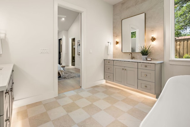 5615 Shoalwood Ave, Austin, TX 78756 - bathroom featuring vanity, a soaking tub, baseboards, recessed lighting, and ensuite bathroom