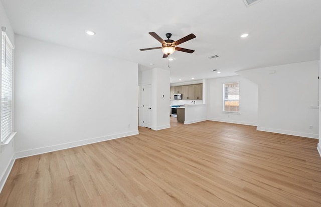 577 Tailwind Dr, Kyle, TX 78640 - unfurnished living room with a ceiling fan, light wood-style floors, baseboards, and recessed lighting