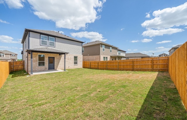 577 Tailwind Dr, Kyle, TX 78640 - rear view of property featuring a patio and brick siding