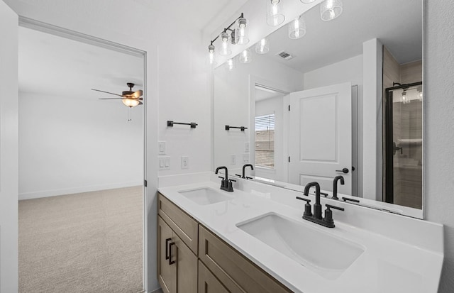 577 Tailwind Dr, Kyle, TX 78640 - bathroom featuring double vanity, ceiling fan, a shower with shower door, and baseboards