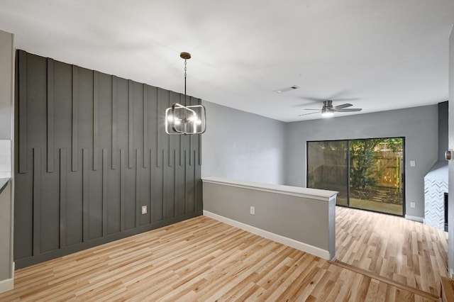 11821 Bittern Holw Unit 27, Austin, TX 78758 - unfurnished room with wood finished floors, baseboards, a chandelier, and a ceiling fan