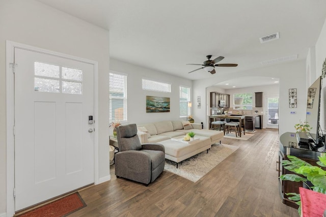 14411 Frankel Loop Unit 32B, Pflugerville, TX 78660 - living area with wood finished floors, ceiling fan, and arched walkways