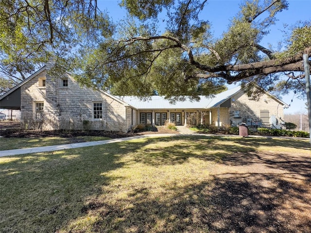 14411 Frankel Loop Unit 32B, Pflugerville, TX 78660 - view of front of home featuring a front yard and stone siding