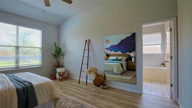 520 Elm Green St, Hutto, TX 78634 - bedroom featuring multiple windows, wood finished floors, vaulted ceiling, and ceiling fan