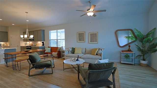 520 Elm Green St, Hutto, TX 78634 - living room featuring light wood finished floors, ceiling fan, a chandelier, baseboards, and recessed lighting