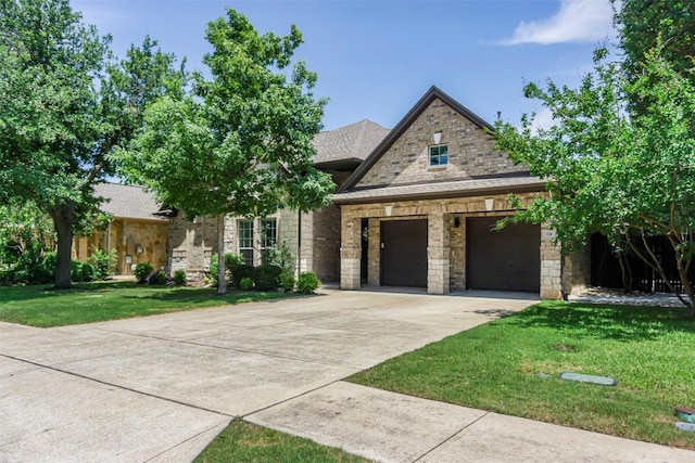 114 Mcbride Ln, Cedar Park, TX 78613 - view of front of house featuring a front lawn, driveway, stone siding, a garage, and roof with shingles
