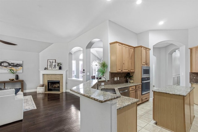 114 Mcbride Ln, Cedar Park, TX 78613 - kitchen with appliances with stainless steel finishes, a sink, light stone countertops, light brown cabinets, and tasteful backsplash