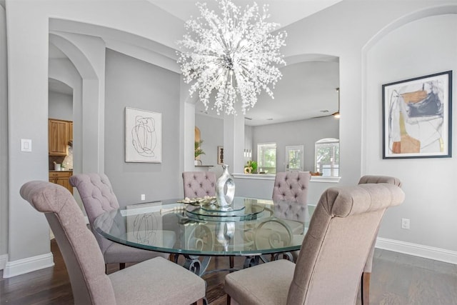 114 Mcbride Ln, Cedar Park, TX 78613 - dining room featuring arched walkways, wood finished floors, a chandelier, and baseboards